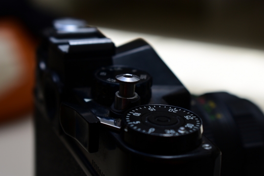 桌面摆放漆黑外观单反相机虚化背景特写
