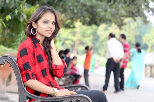 人物摄影_城市公园长椅上红色格子衬衫长发女性