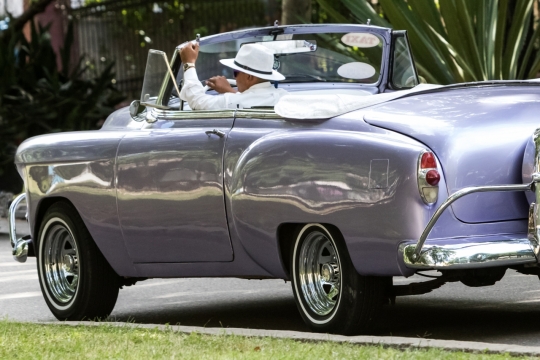 城市街道马路上驾驶银色敞篷轿车男性