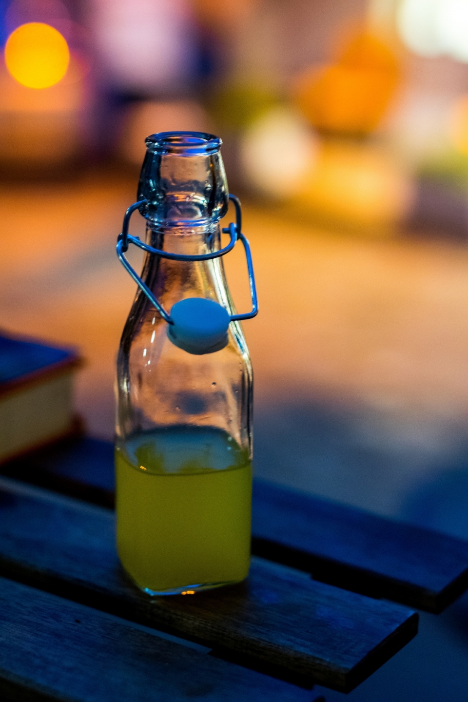 虚化灯光背景木制桌面玻璃瓶新鲜果汁