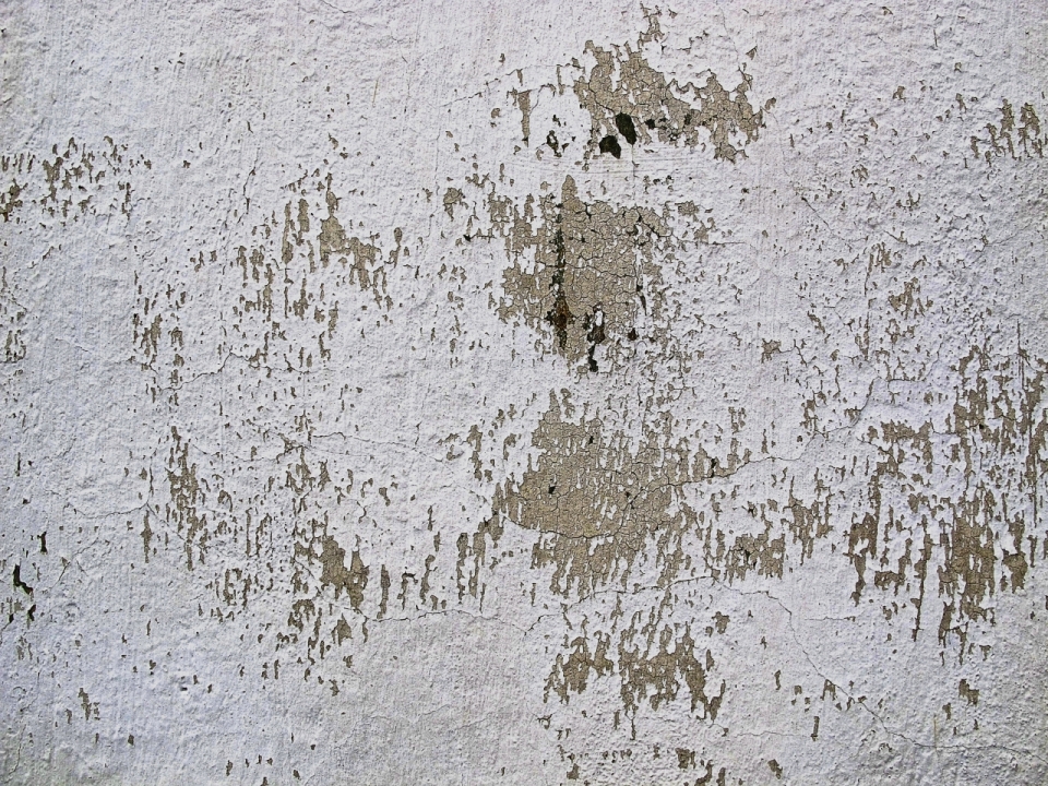 老旧斑驳白色油漆脱落的墙壁