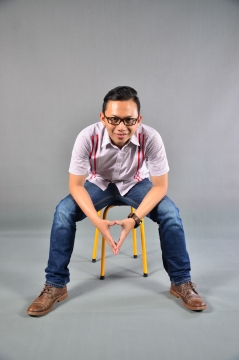 短发戴眼镜衬衫手表男性坐黄色凳子