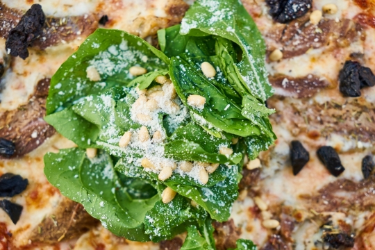 孜然牛肉蔬菜披萨上的蔬菜特写摄影