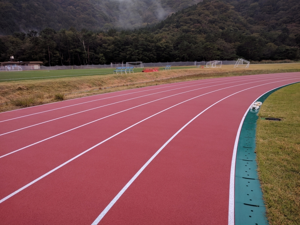 大山包围中操场的红色跑道摄影