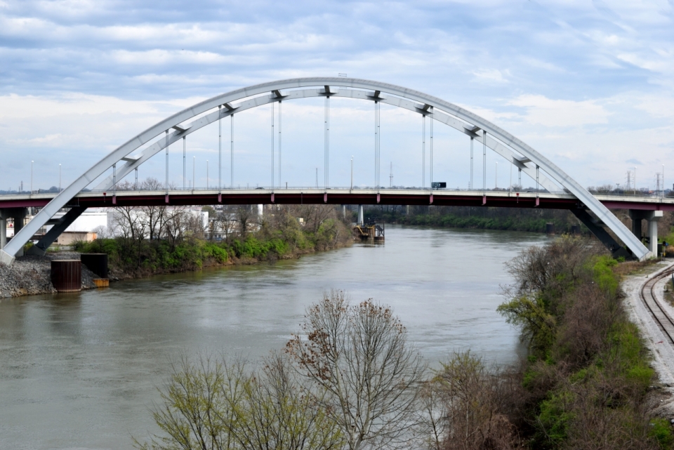 弧形金属桥梁河流两岸植物风景
