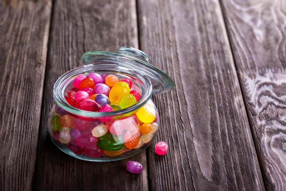 复古餐桌上摆放着一罐彩色糖果美食摄影