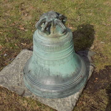 草地石头上青色古钟静物摄影