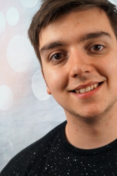 人物摄影_波点图案背景短发穿黑色T恤年轻男性