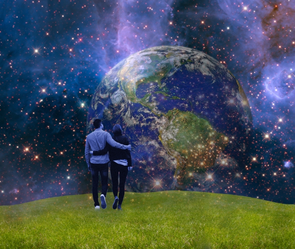情侣互相搂着走在草地上看唯美宇宙中的地球