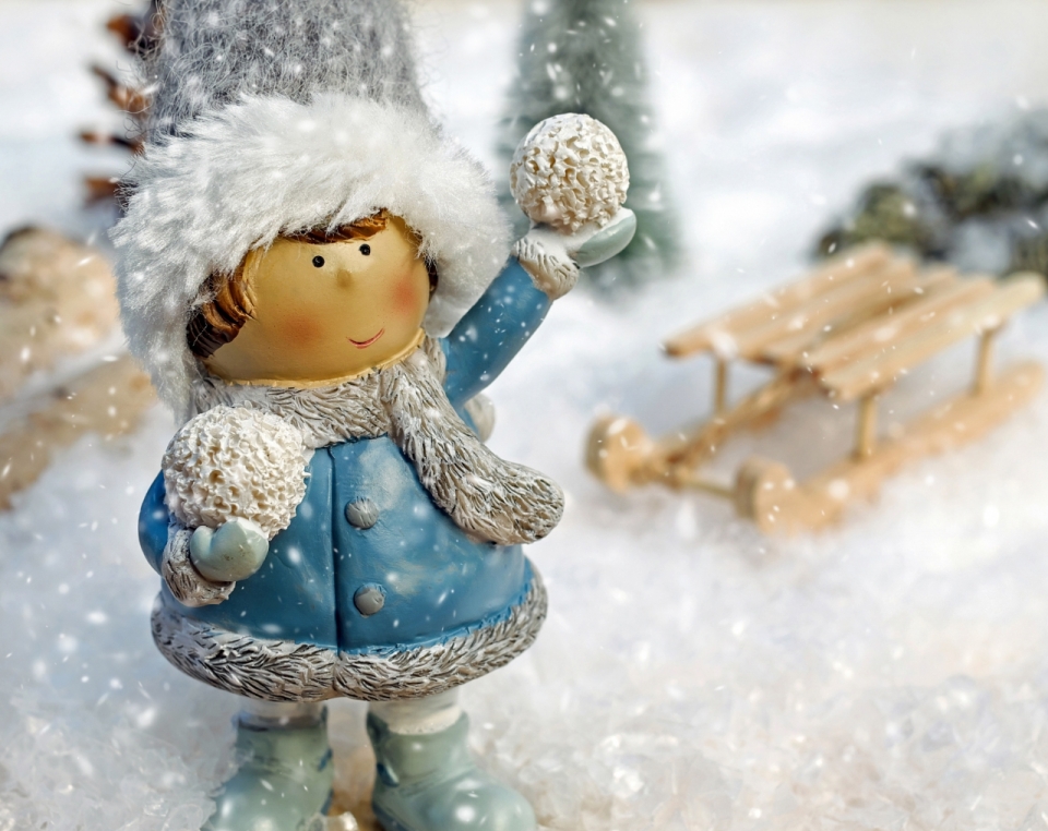 冬天雪地上拿着雪球的小女孩玩具摄影