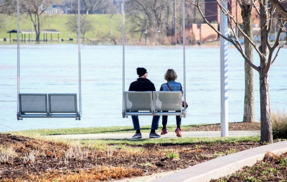 城市户外自然公园湖泊前荡秋千情侣