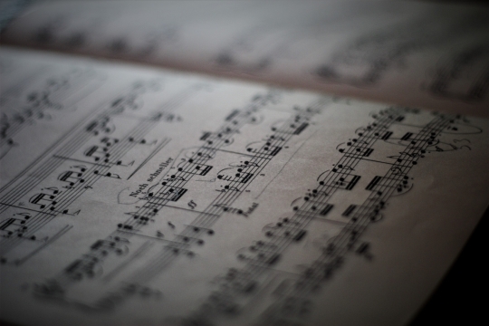 昏暗室内桌面摆放乐谱微距