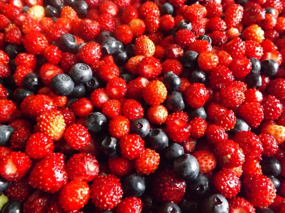 堆放在一起的新鲜草莓和蓝莓水果摄影