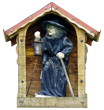 白色背景木屋中黑袍巫婆工艺品