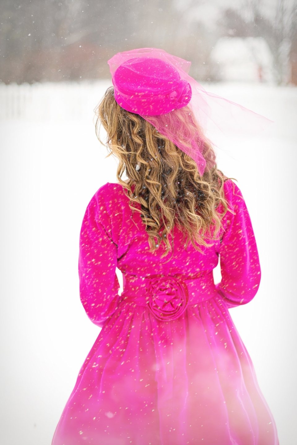 冬天城市穿鲜艳粉色帽子裙子长发女性