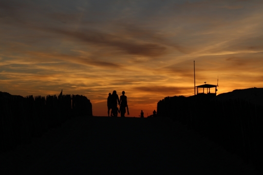 黄色落日天空下城市道路行人剪影