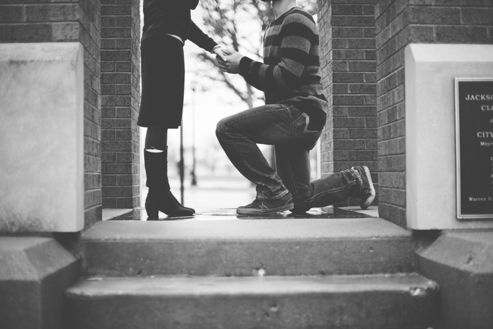 单膝下跪向女人求婚的男人黑白风格摄影